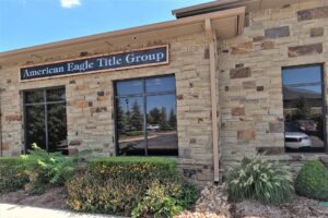 The outside of a building with a sign entitled "American Eagle Title Group"