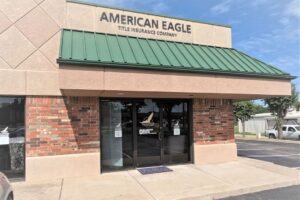The exterior of a building with a sign reading "American Eagle Title Insurance Company"