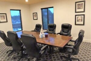 black office chairs encompass a wooden table