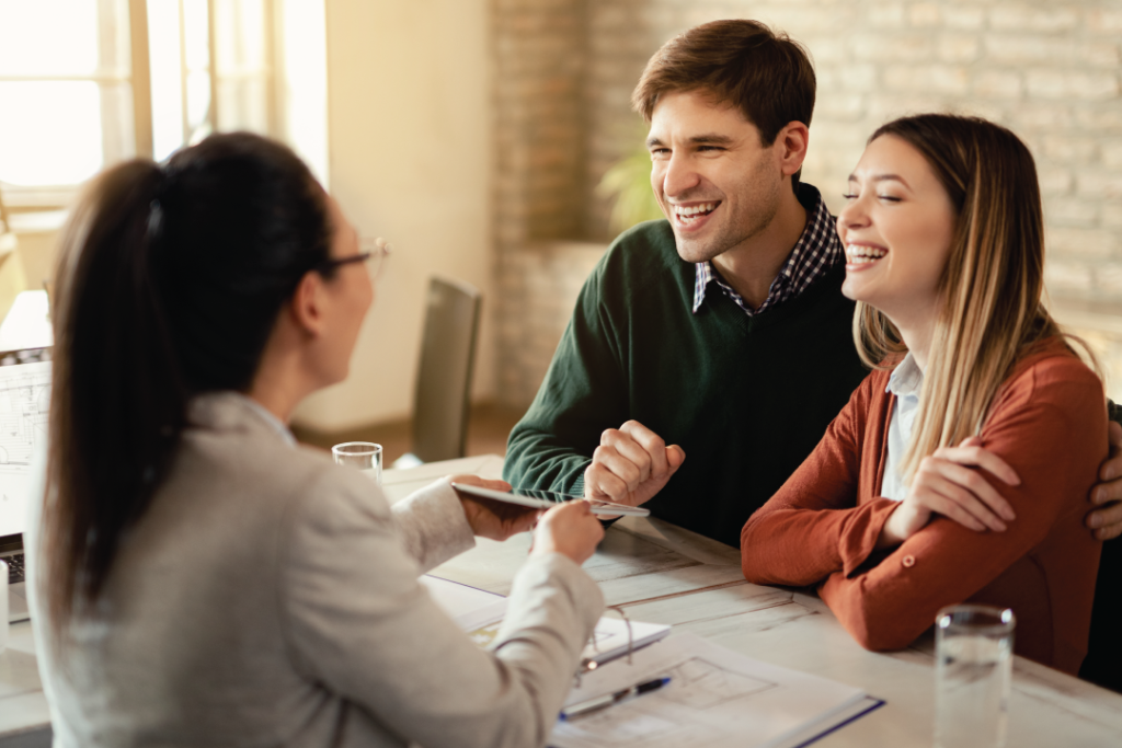 Couple meeting with an insurance agent in her office.