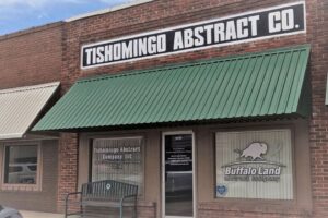 The outside of a building with a sign entitled "Tishomingo Abstract Co."